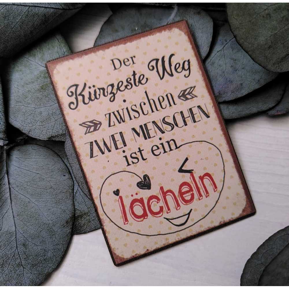 Magnet "Der Kürzeste Weg zwischen zwei Menschen ist ein Lächeln"